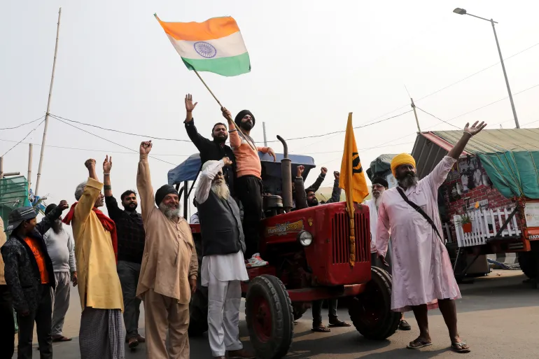 Indian Farmers celebrate Indian government's decision to repeal the controversial farm laws, at Ghazipur protest site outside New Delhi, 2021 