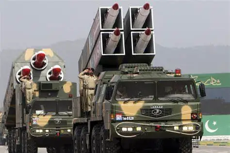 On March 23, 2022, in Islamabad, Pakistani soldiers stand atop a vehicle transporting the Shaheen long-range ballistic missile during a parade.