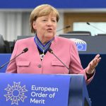 Europe’s Ironies: Merkel and Zelensky Cement Legacies with Grand Order
