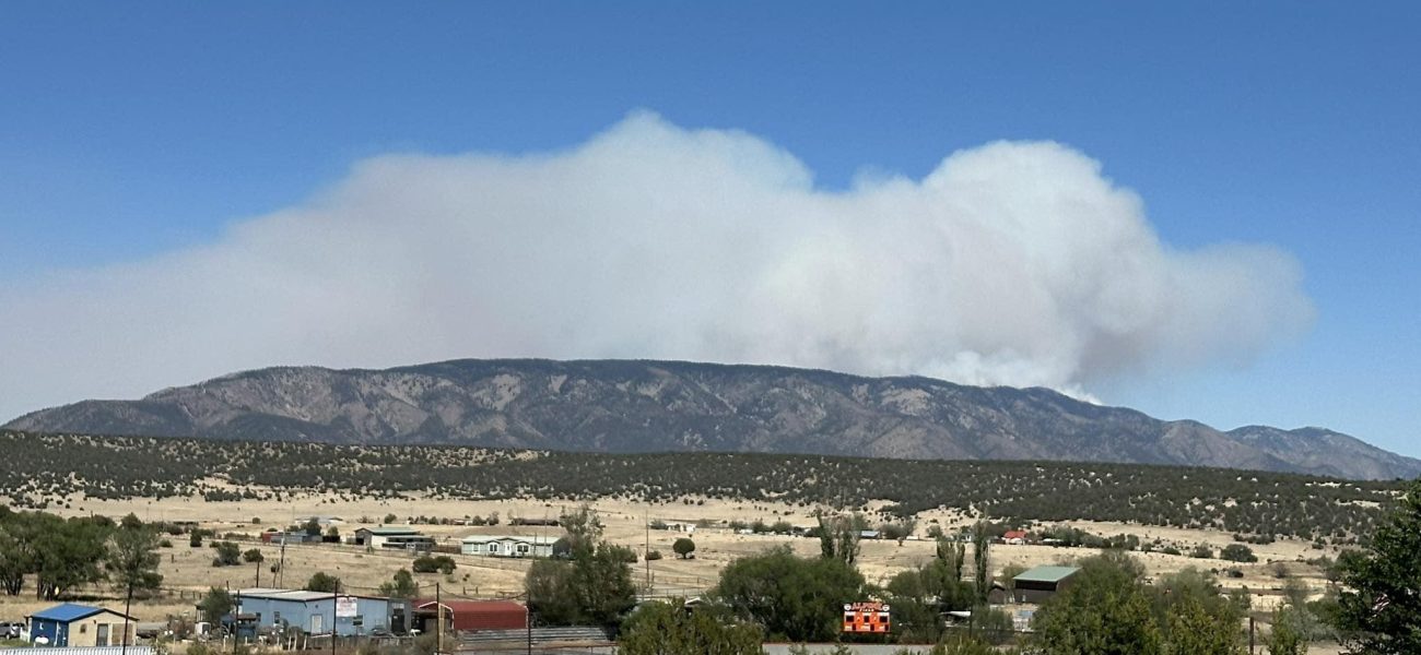 Inferno Unleashed: Winds Whipsaw New Mexico Blaze as Fatal Crash Lingers