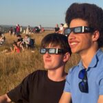 Hundreds Gather Safely on Hillside to Witness Rare Solar Eclipse
